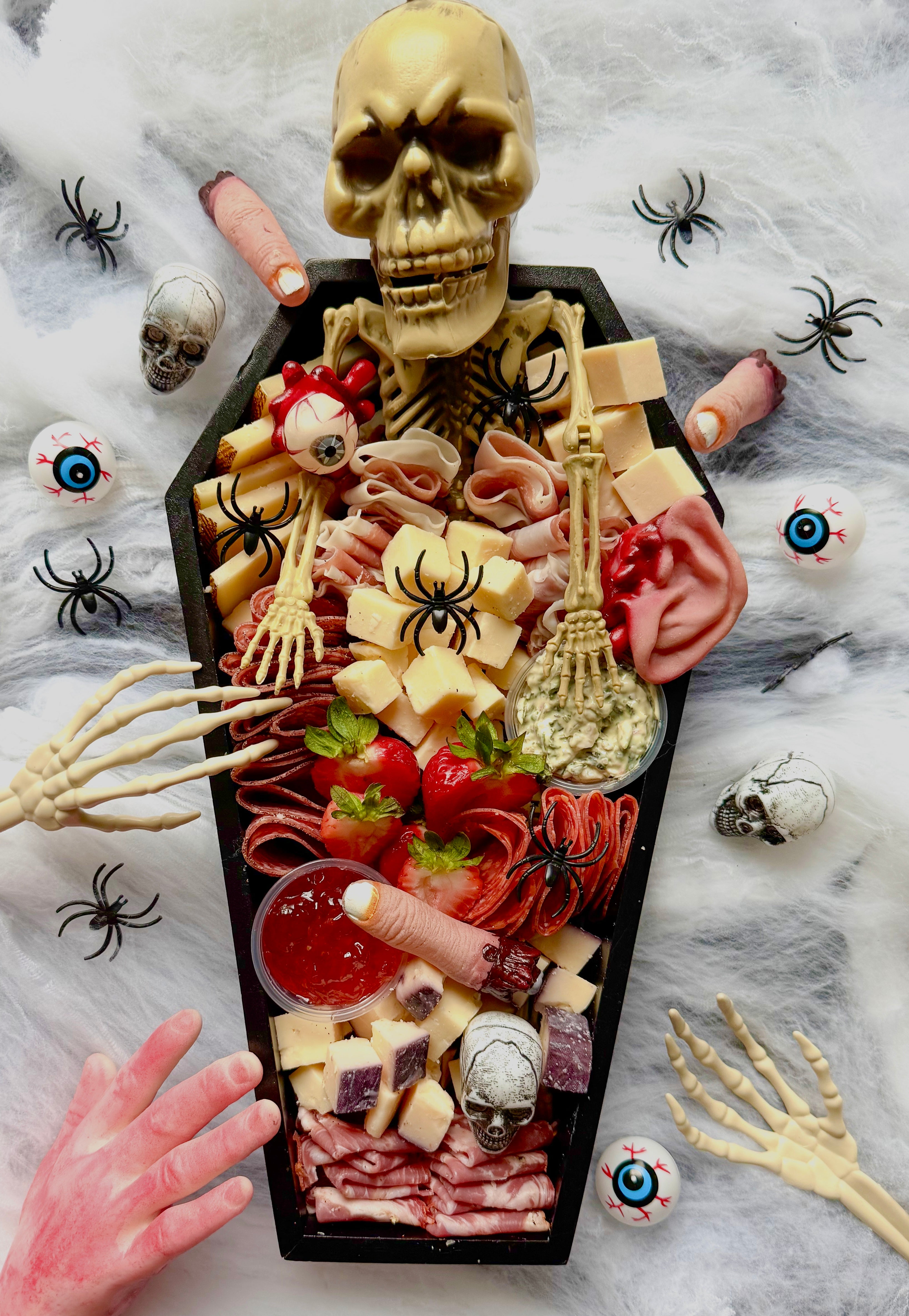 Spook Up Your Event with Luxe Bites’ Coffin-Shaped Charcuterie Board